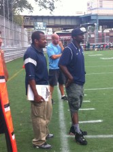Canarsie football coaching staff looks on from sidelines. 